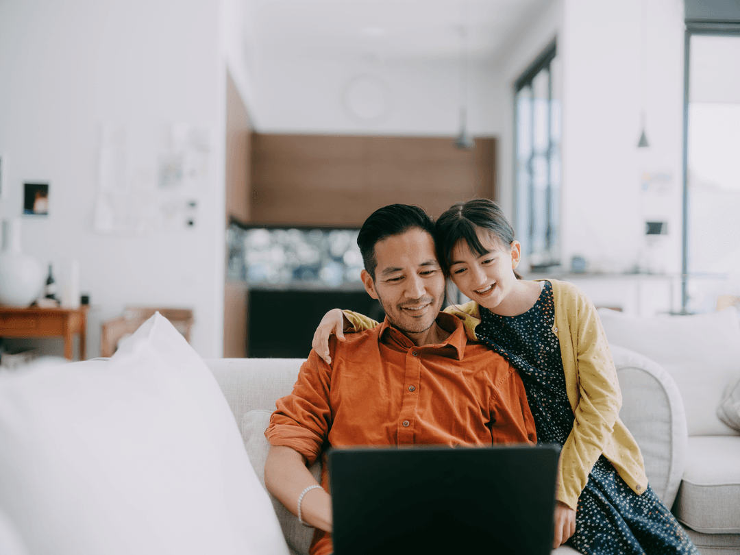 A family looking at a laptop together at home